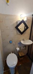 a small bathroom with a toilet and a sink at Casa Caiçara Centro in Paraty