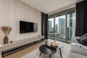 a living room with a tv and a couch at Nikas Eurovea Apartments - free parking in Bratislava