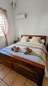 a bedroom with a bed with two towels on it at Villa MIA in Saint-François +14 photos
