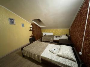 Postel nebo postele na pokoji v ubytování Guest House Na Suvorova