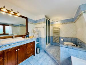 a bathroom with a tub and a sink and a mirror at YourHome - Casa Carmela in Colli di Fontanelle +28 photos