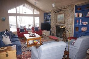 a living room with a couch and a fireplace at 327 Deer Ridge Ln (203145-2295) Home in Snowmass Village