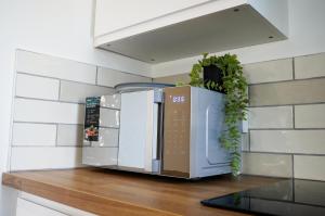 a microwave sitting on top of a wooden counter at Church Street Studio Apartment in Keighley