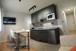 a kitchen with a small table and a microwave at AturCangas in Cangas de Onís