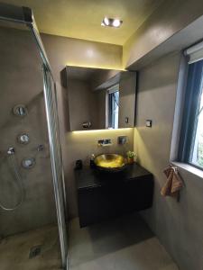 a bathroom with a sink and a shower at Athina Art Apartments in Athens