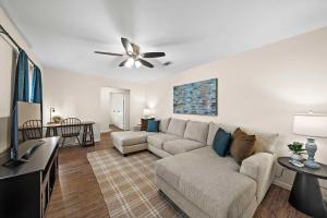 a living room with a couch and a ceiling fan at Cozy and Stylish 3-Bedroom Sanctuary in Seabrook