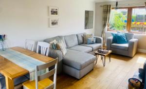 a living room with a couch and a table at Fairview House in Caol