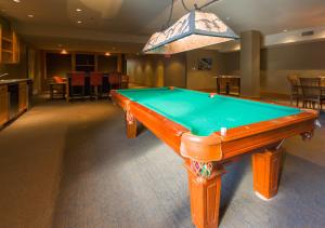 a pool table in the middle of a room at Slalom Creek 3 Bedrooms in Rossland