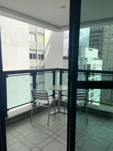 a balcony with a table and chairs on a building at Transamerica Paradise Garden in São Paulo