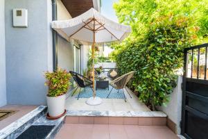 a patio with two chairs and an umbrella at Maria Home Reall's in Braga
