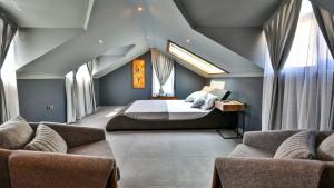 a bedroom with a bed and two couches at Luxury Villa Close to Shops and Restaurants -Large Garden Pool Table and Table Tennis in Fethiye +83 photos