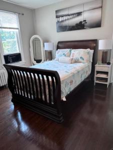 a bedroom with a bed and a mirror at Bloom Victorian Bed & Breakfast in South Orange +34 photos
