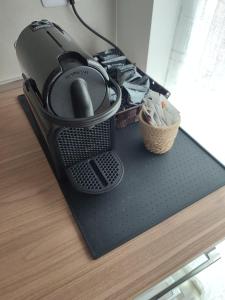 a iron sitting on top of a table at Casa ElaBon - Rozzano Vicino Humanitas, IEO, Forum Assago, Duomo in Rozzano +40 photos