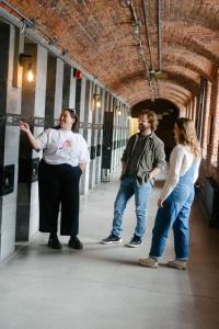 a group of people standing in a hallway at Saintlo Ottawa Jail Hostel in Ottawa