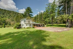 a home with a large yard with a house at Pet-Friendly Home with Game Room in Hillsgrove! in Hillsgrove