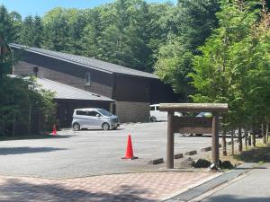 a white van parked in a parking lot with orange cones at Dormy Club Karuizawa in Karuizawa