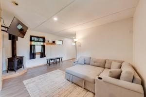 a living room with a couch and a fireplace at Pet-Friendly Cabin with Grill in Hillsgrove in Hillsgrove