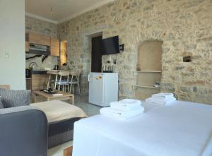 a kitchen and a living room with a refrigerator at Rigas stone tower east Mani 1 in Mína