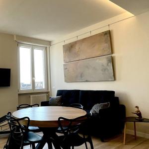 a living room with a table and a couch at Elements in Rome