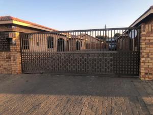 a wooden fence in front of a house at Cass Villa 25 Kimberley in Kimberley