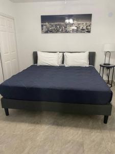 a bed in a bedroom with a blue bedsheet at AWESOME PLACe in Las Vegas