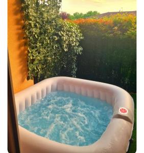 a hot tub in a backyard with a garden at Escale marine in Saint-Jory