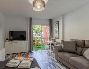 ベナルマデナにあるApartamento Estudio Vacacional Iris, Benalmádenaのソファとテレビのあるリビングルーム