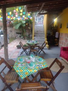 a patio with a table and chairs with plates and dishes at Aurora suites chapada Diamantina in Lençóis