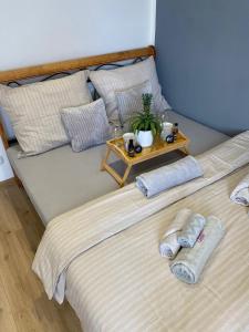 two beds with towels and a table on top at ZnojmoApartment in Znojmo