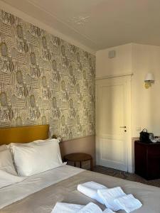 a bedroom with a bed with two towels on it at B&B Dimora Liberty in Genoa +27 photos