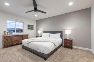 a bedroom with a bed and a ceiling fan at Hot Tub, Heber Home, Pet-Friendly, Games, Sleeps 13 Guest! in Heber City