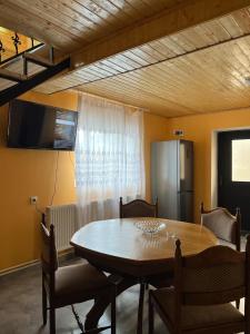 Russa Kottages في Ach'khoti: غرفة طعام مع طاولة وثلاجة