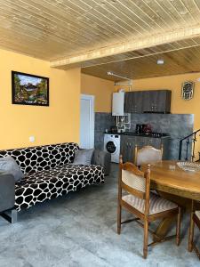 Russa Kottages في Ach'khoti: غرفة معيشة مع سرير وطاولة طعام