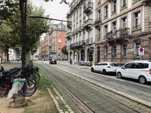 a street with cars parked on the side of the road at Petit nid sympa a Strasbourg in Strasbourg