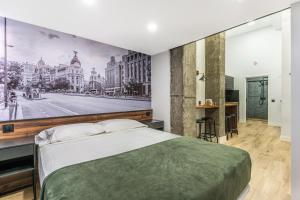 a bedroom with a large painting on the wall at VR OBREGON APARTMENTS in Madrid