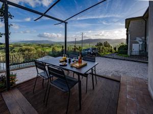 a table and chairs on a patio with a view at Villino Isotta in Terricciola