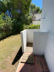 a stairway in a house with a wall and trees at Xalet Argany in Sant Jordi d'Alfama in Les tres Cales