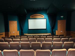 an empty auditorium with chairs and a screen at Luxury 4BD Single-Level Villa with Private Pool - Windsor Palms - Sleeps 8 in Kissimmee +39 photos