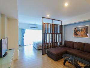 a living room with a couch and a bed at Huahin City View in Hua Hin