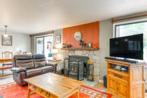 a living room with a couch and a fireplace at West Dover Townhome Hot Tub, 2 Mi to Mount Snow! in West Dover
