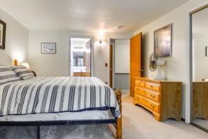 a bedroom with a bed and a dresser and a mirror at West Dover Townhome Hot Tub, 2 Mi to Mount Snow! in West Dover