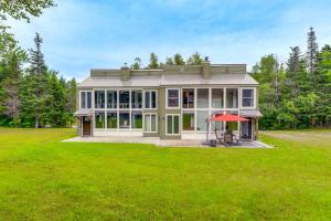 a large house with a green lawn at West Dover Townhome Hot Tub, 2 Mi to Mount Snow! in West Dover