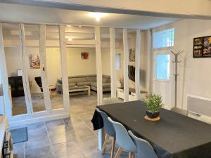 a living room with a table and chairs and a couch at A&J Family - Neuvy sur Loire - Guédelon in Neuvy-sur-Loire +13 photos