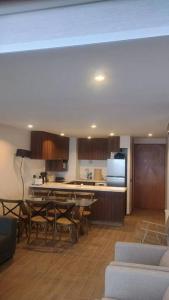 a kitchen and dining room with a table and chairs at Gran Parador SKI In SKI Out El Colorado Chile in El Colorado
