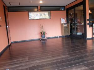 a lobby with a vase with flowers in it at Yamanokami Onsen in Nagano