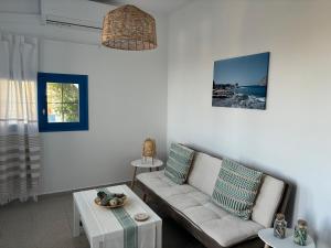 a living room with a couch and a table at Mochlos Thea Thalatta in Mochlos