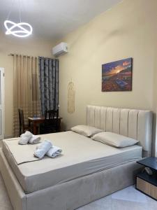 a bedroom with a large bed in a room at Rei's room in the city center in Durrës