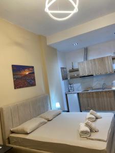 a bedroom with a bed with towels on it at Rei's room in the city center in Durrës