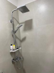 a shower in a bathroom with a shower head at Rei's room in the city center in Durrës +20 photos