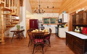 a kitchen with a wooden table and chairs and a dining room at Simones Cottage in Gatlinburg
